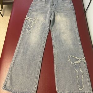 Women's Light Washed Blue Jeans with Distressed Bow Detailing
